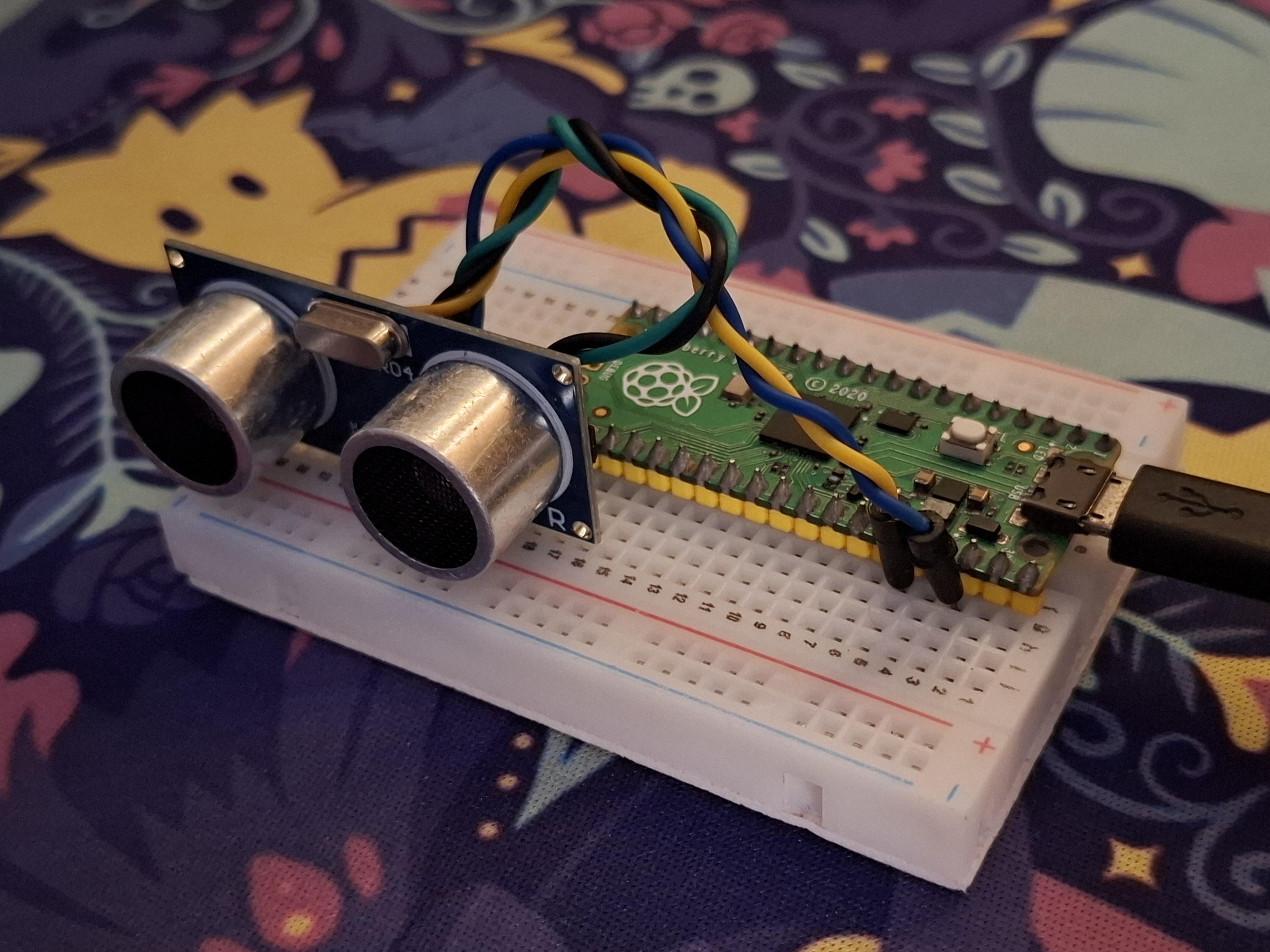 In real life mounted circuit with Raspberry Pi Pico and HC-SR04.